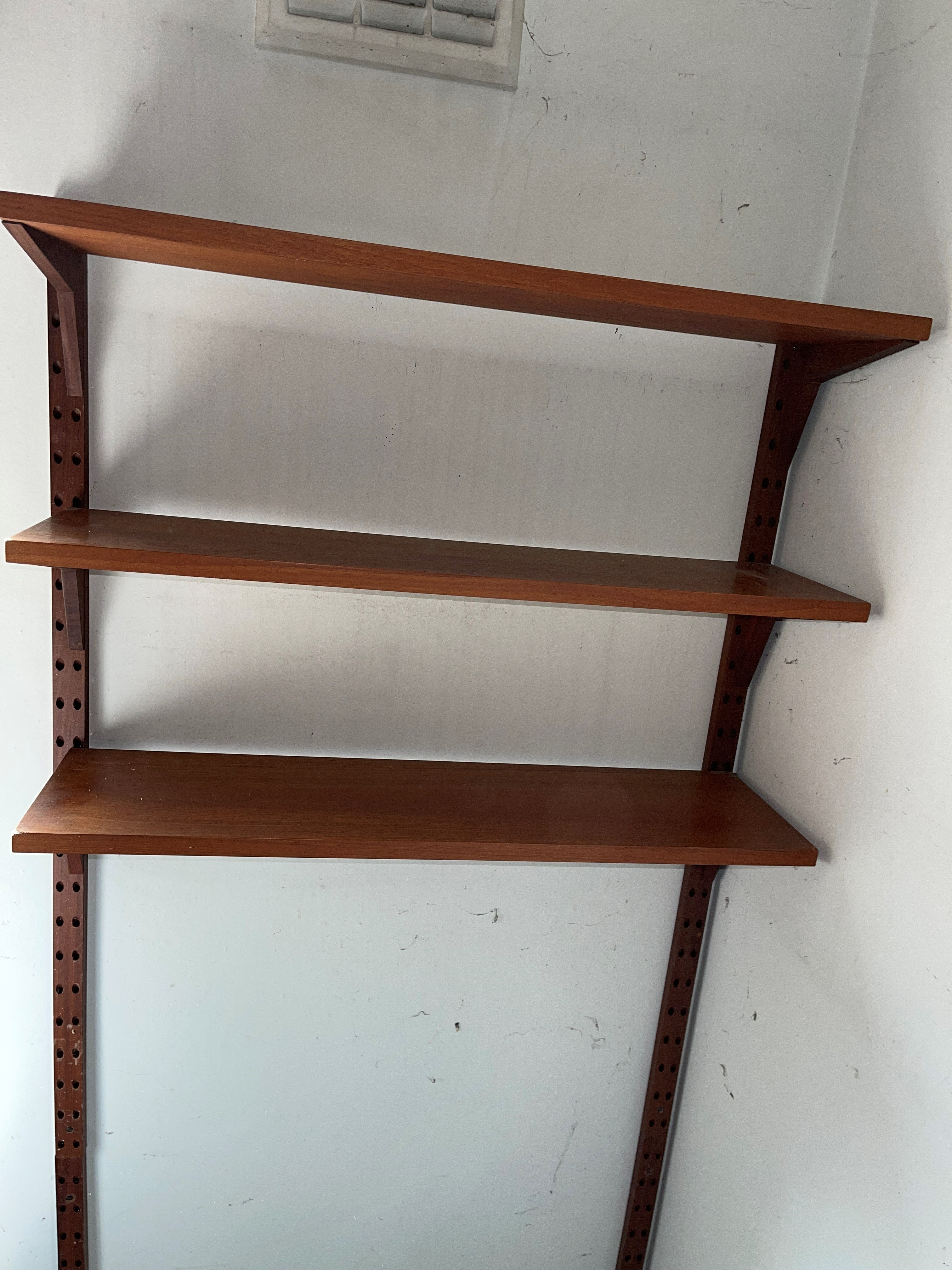 A mid century teak Poul Cadovius teak 'Lado' wall shelving system